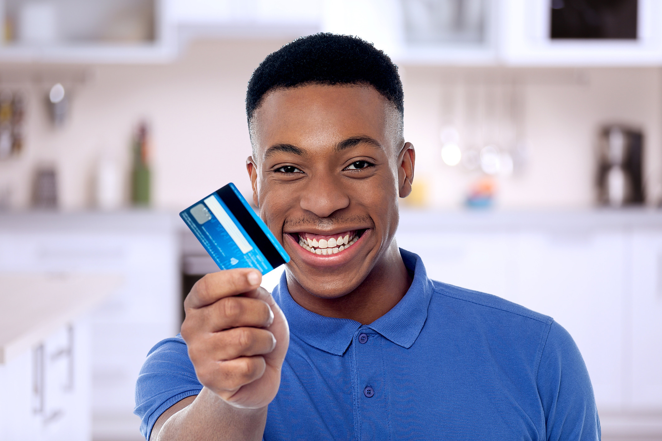 Man holding credit card and smiling