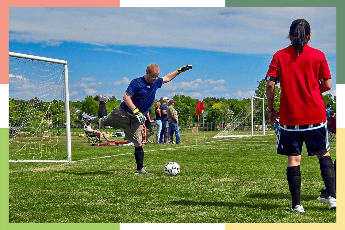 A male Regional Center resident kicks a soccer ball