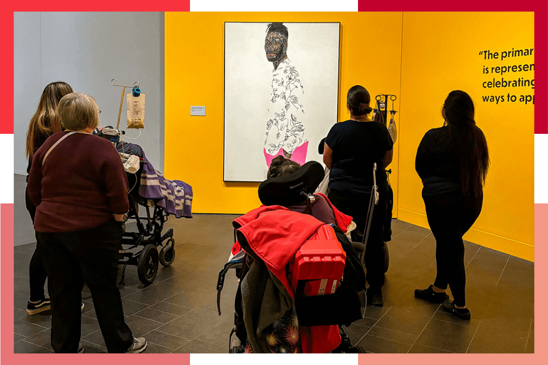 A group of Wheat Ridge Regional Center residents and staff gaze at a piece of art