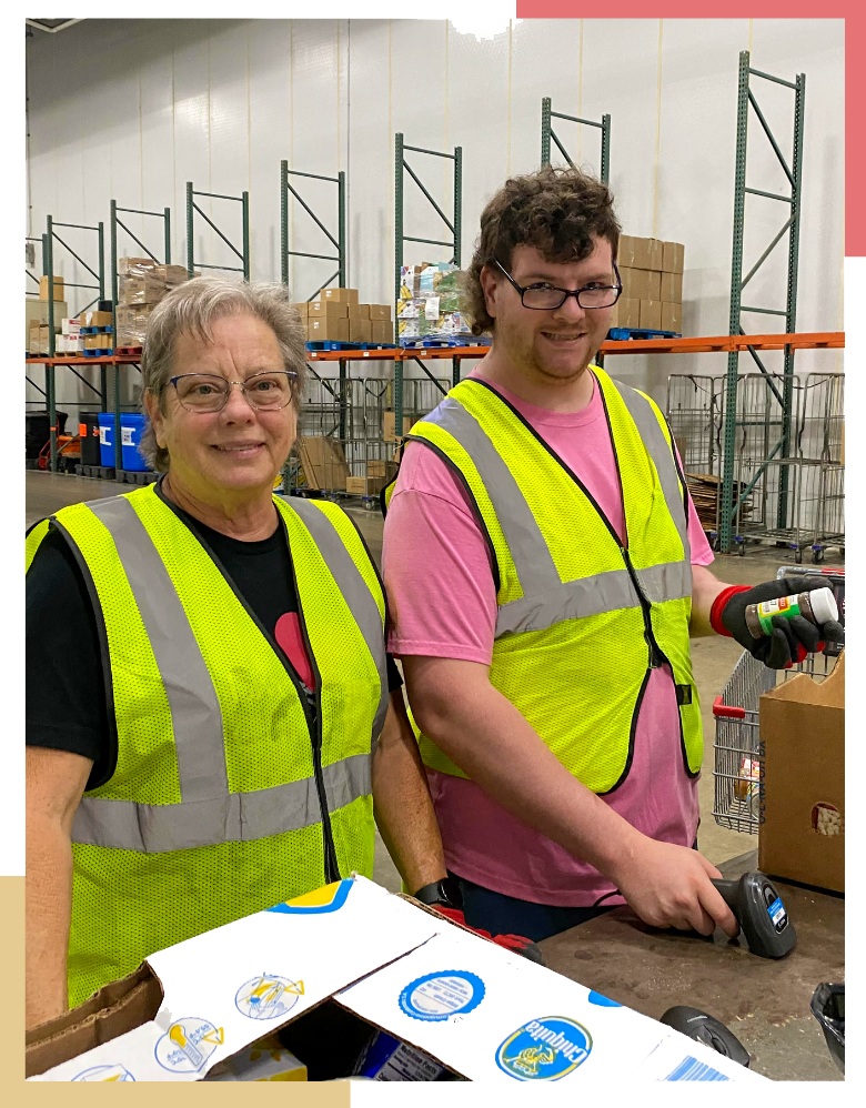 A male Regional Center resident and supervising woman smile while scanning packaged food items