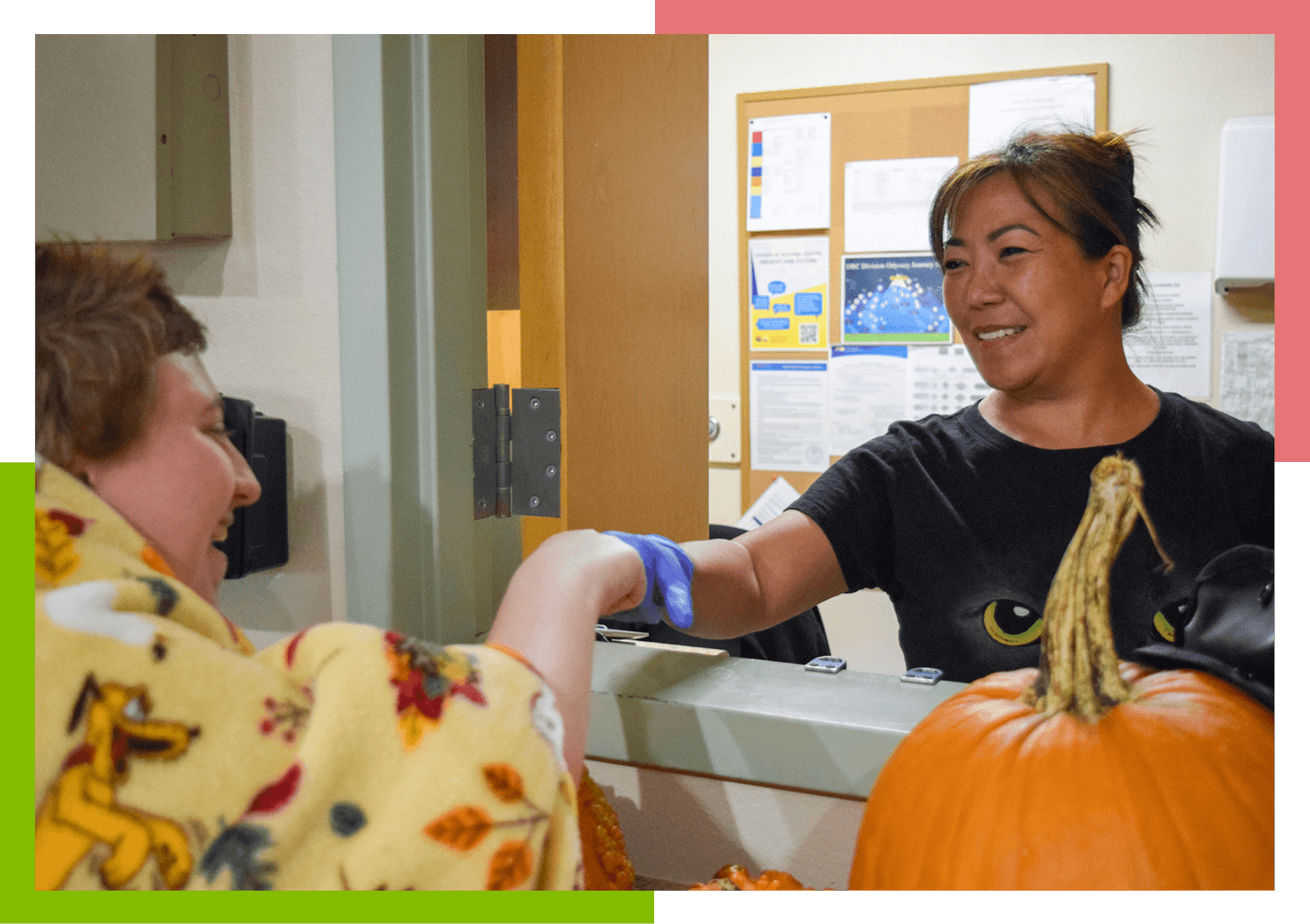 A Pubelo Regional Center female staff member fist bumps a female resident.