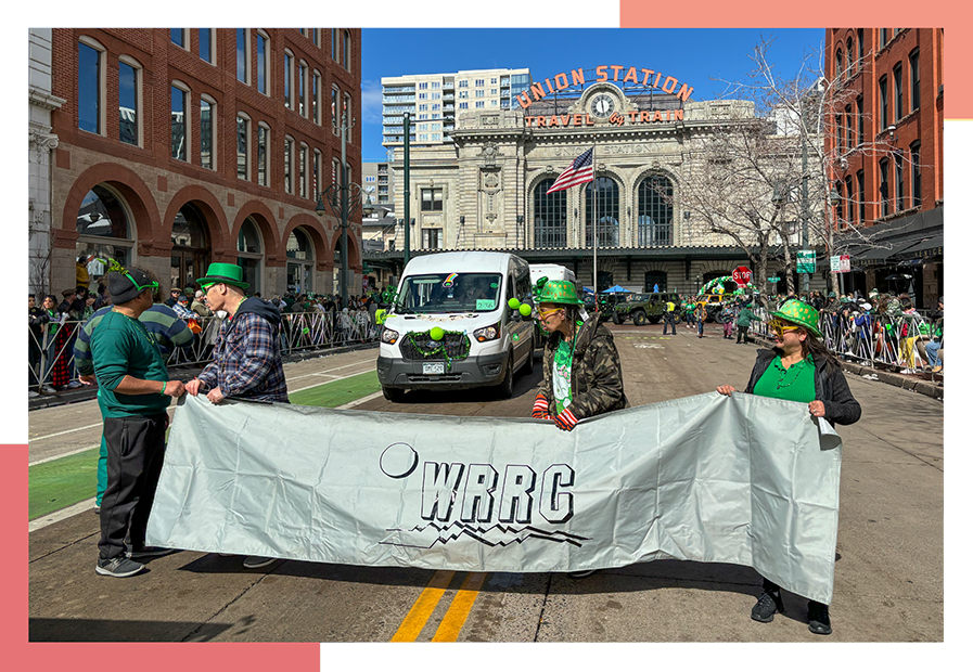 Wheat Ridge Regional Center residents hold a WRRC banner and march in a St. Patrick's Day parade