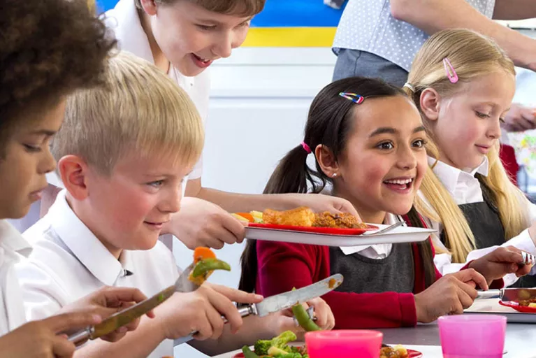 Children in school cafeteria eating lunch