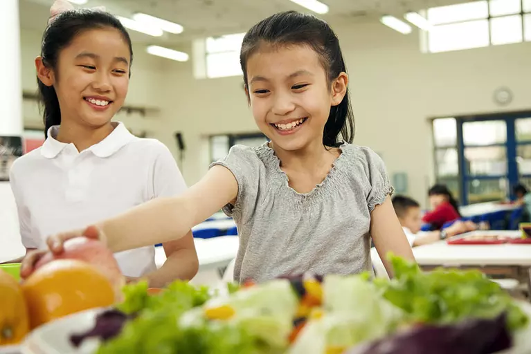 Children in school cafeteria getting lunch