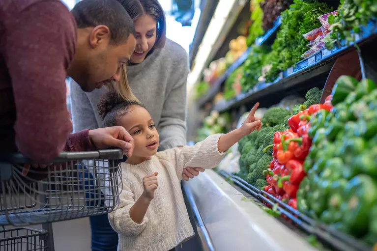 Parents and child shopping for healthy food