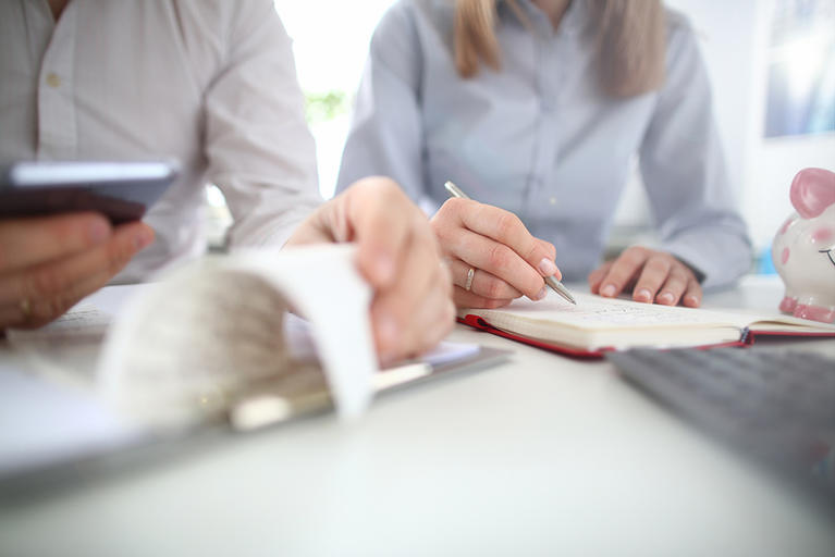 Couple working on paying bills at desk