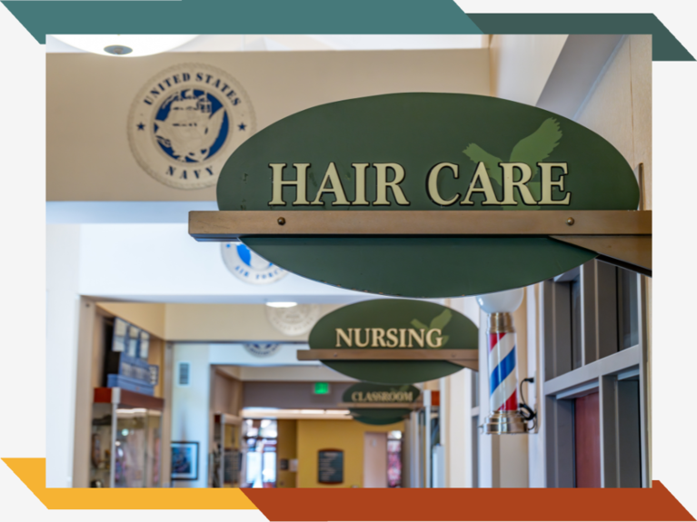 Door signs in a long hallway that read "Hair Care", "Nursing", and "Classroom".
