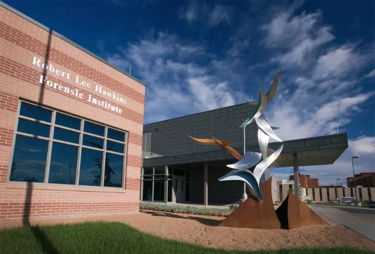 Front entrance of a building at Colorado Mental Health Hospital in Pueblo, with sculpture in front of building